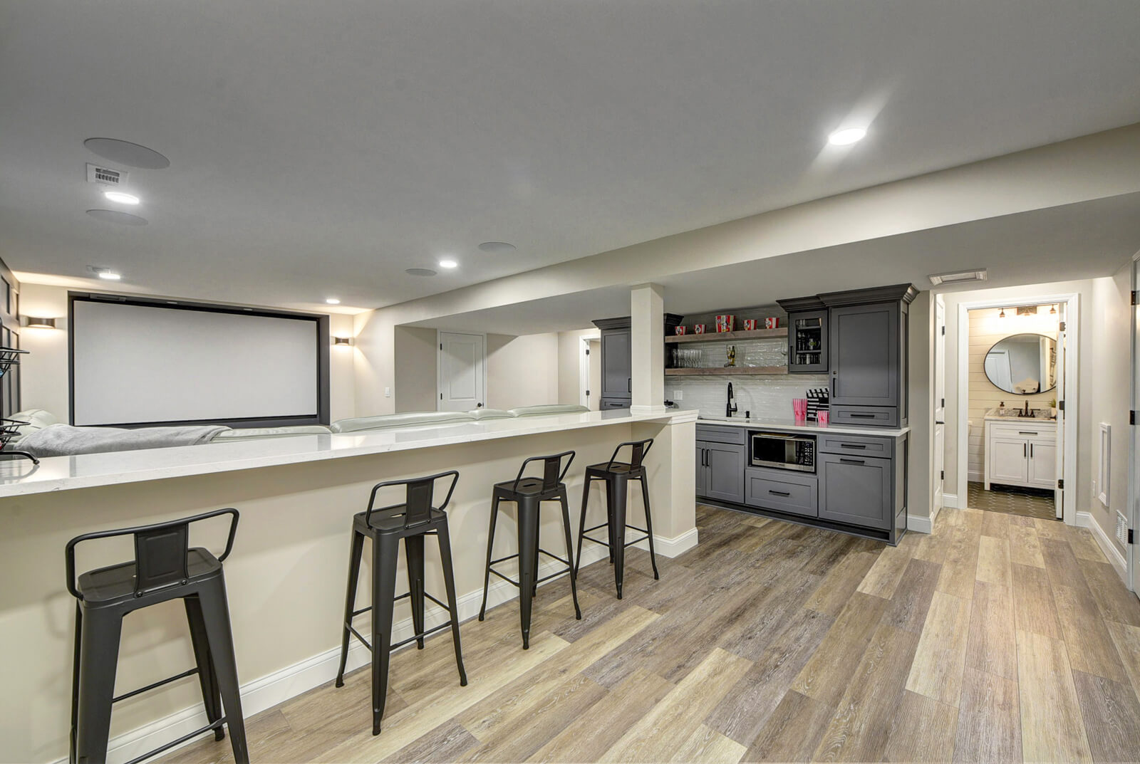 Modern Kitchen with bar Stools and Television projector